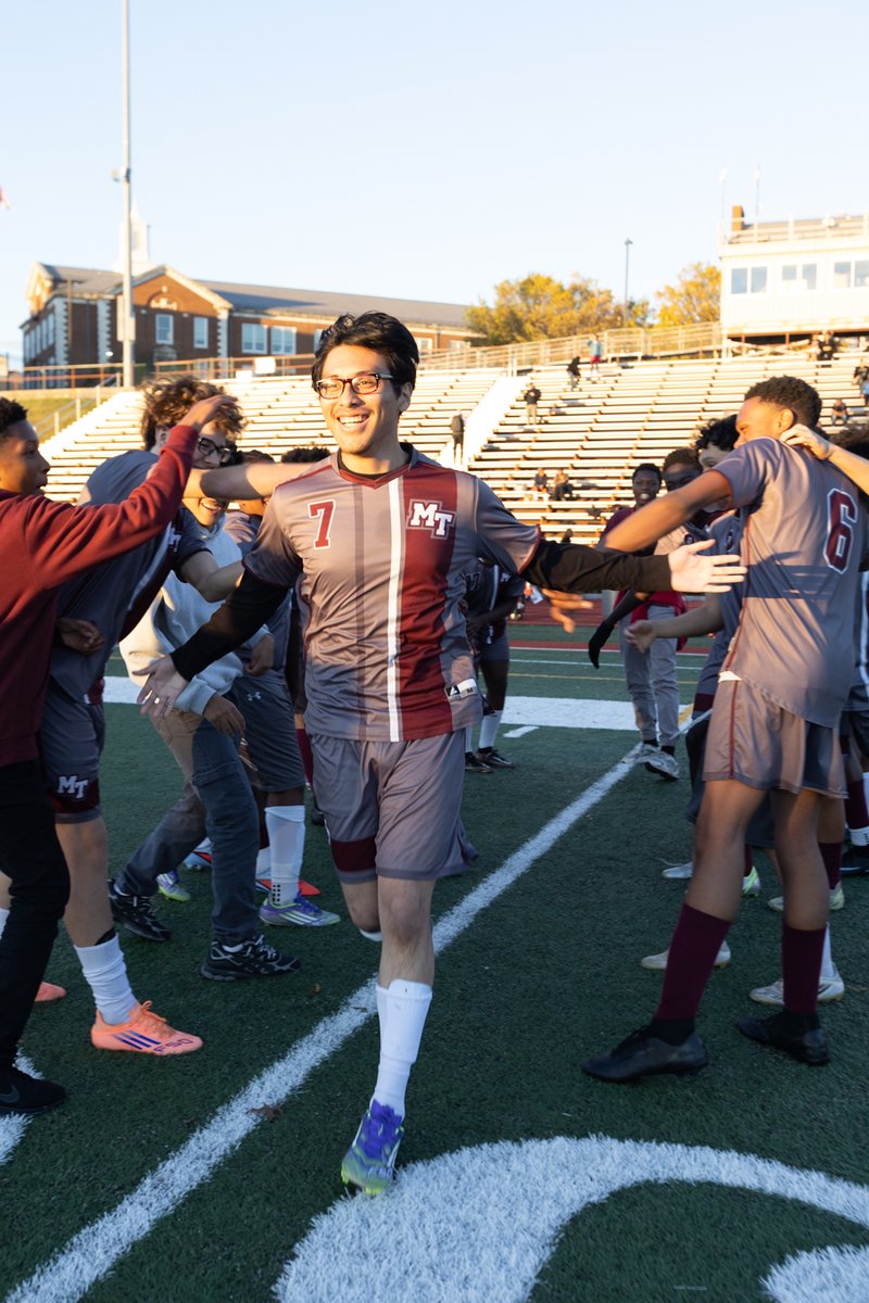 Soccer players celebrating and running downfield